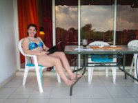 Paula enjoying a book on the patio.